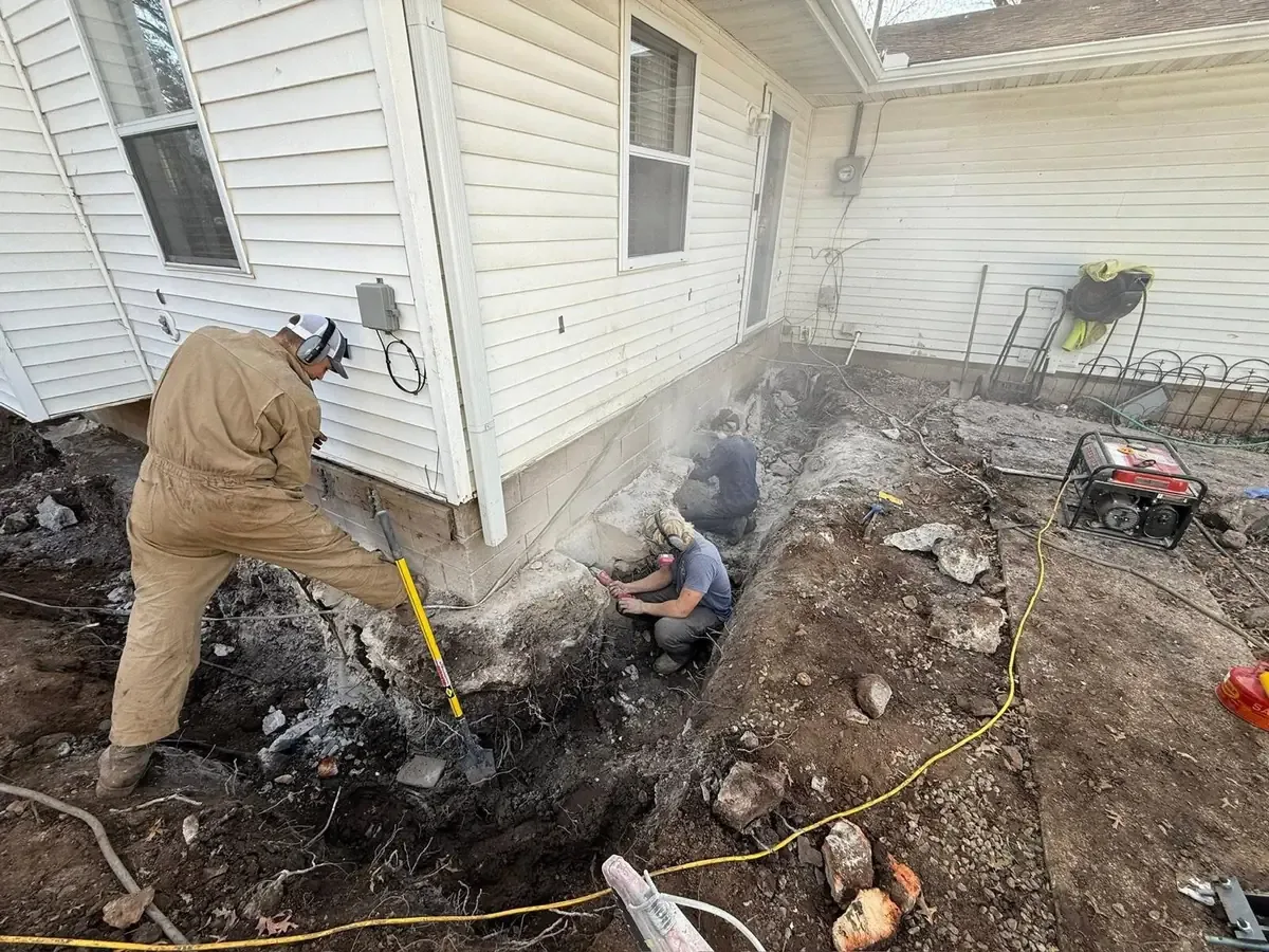 Crew working beside an excavated residential foundation