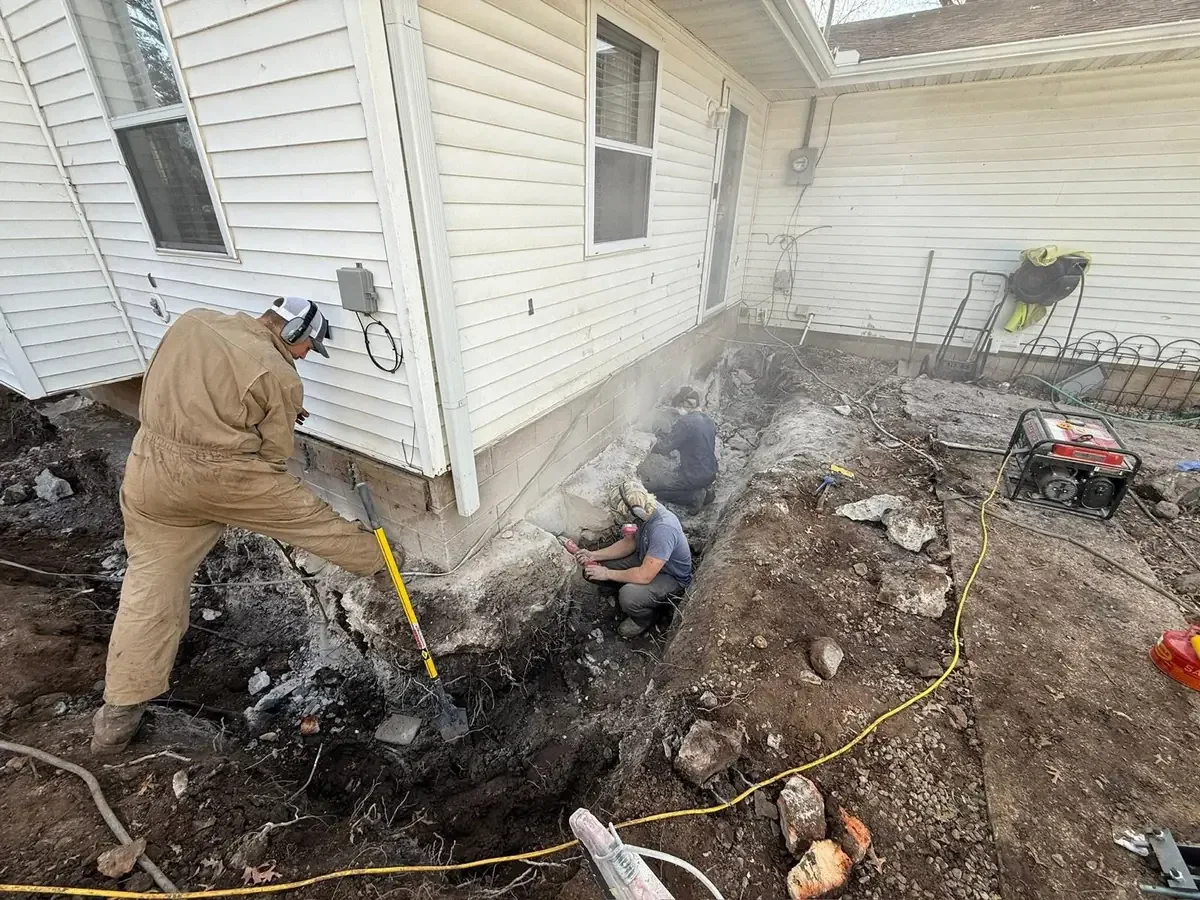 Crew working alongside the excavated foundation of a Chicago-area home