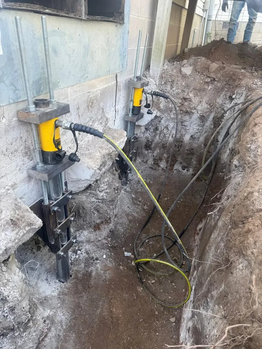 Residential foundation support work in an excavated area